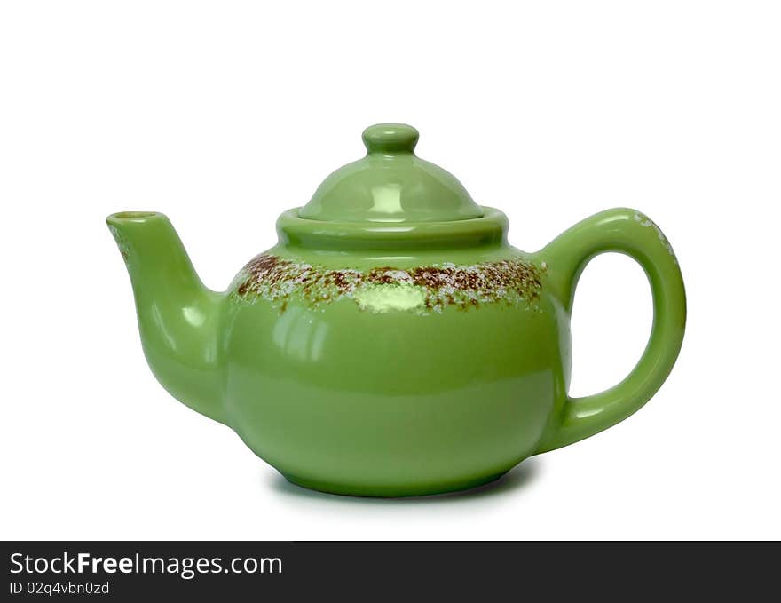 Ceramic teapot of green colour on a white background. It is isolated.