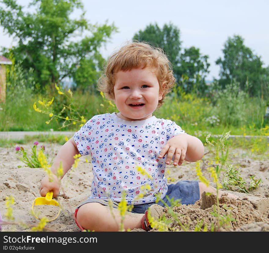 Baby playing on the sand