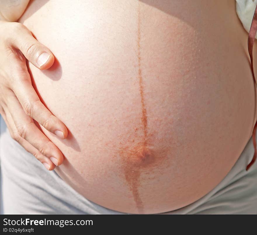 Pregnant woman and exposed belly