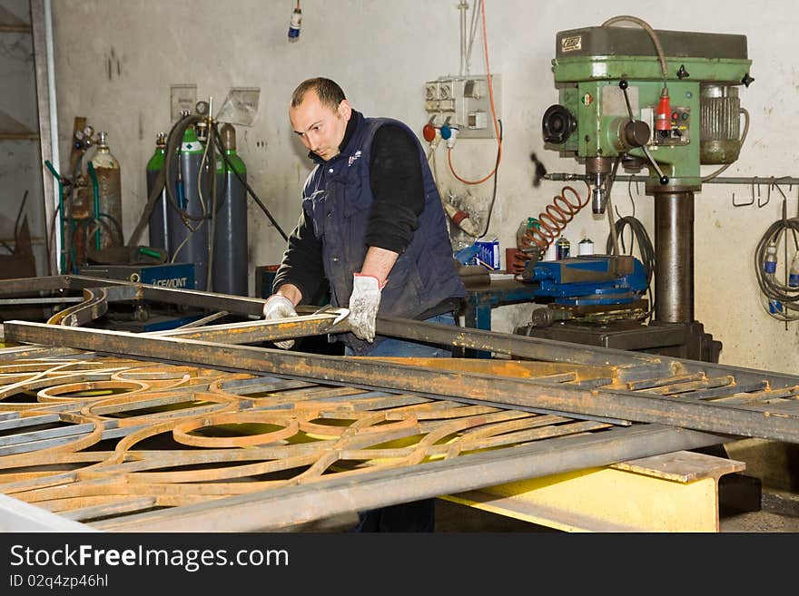 Forging iron in a site in a craftman workshop. Forging iron in a site in a craftman workshop