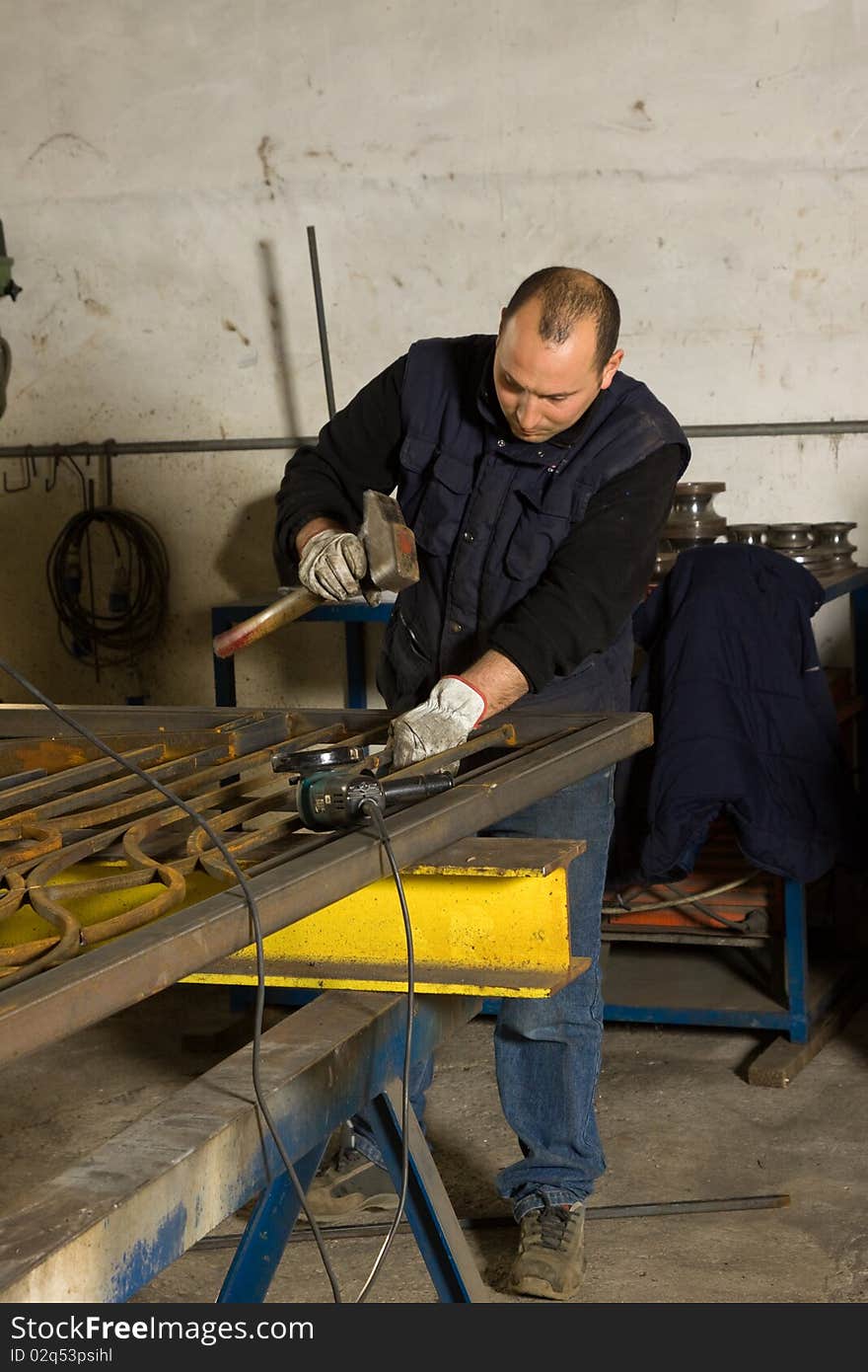 Metalworkers while working in a workshop in a site