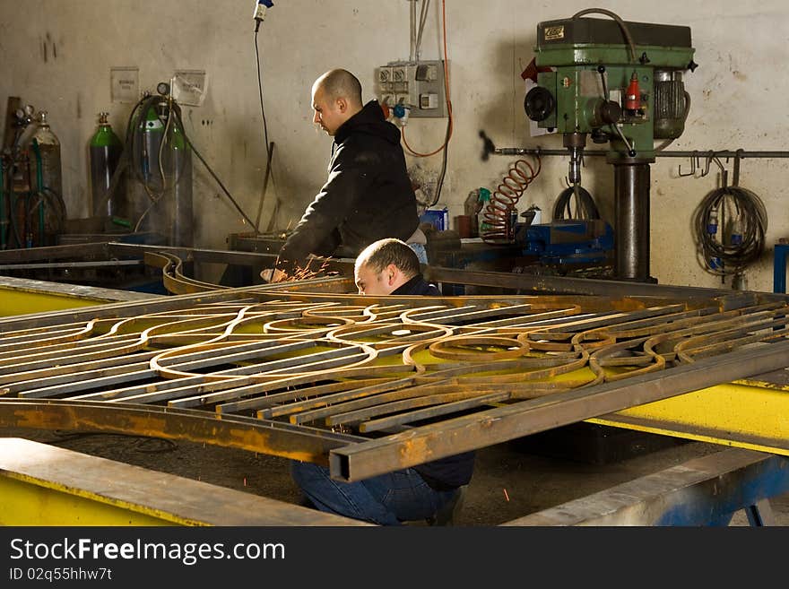 Metalworker working in his workshop forging the iron