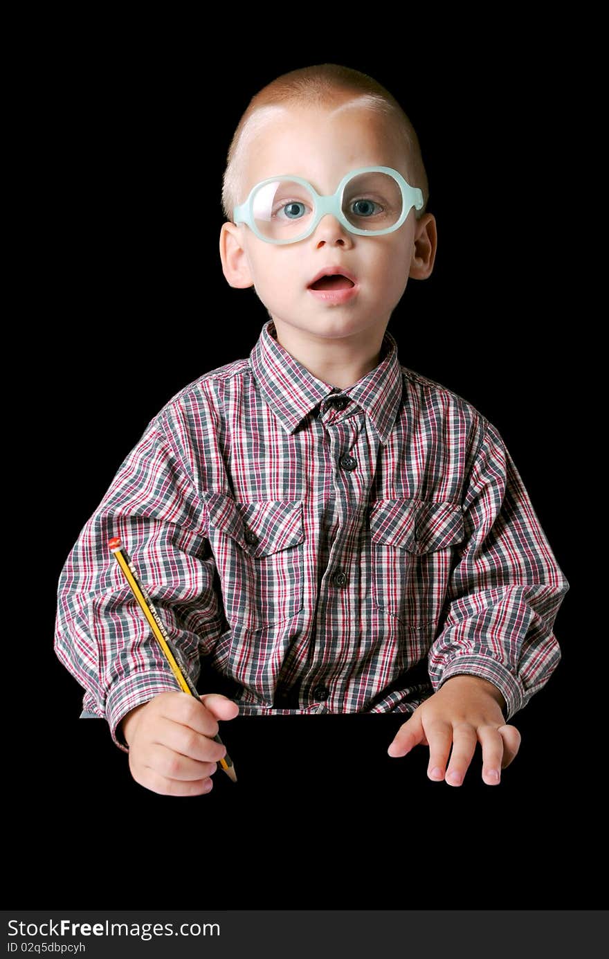 Cute boy with glasses holding a pencil isolated on a black background. Cute boy with glasses holding a pencil isolated on a black background