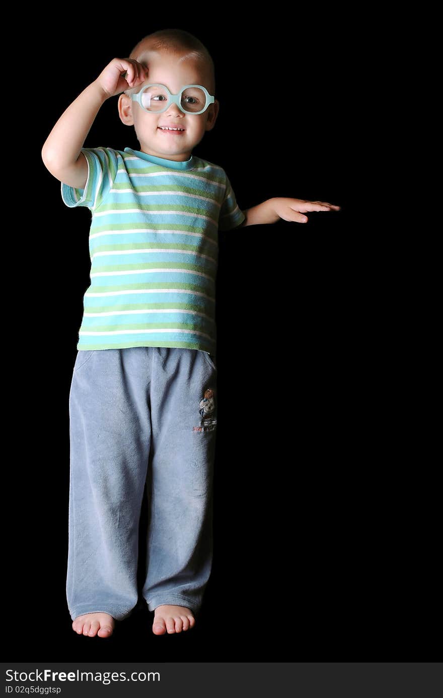 Boy staning on feet, holding one hand up. Boy staning on feet, holding one hand up