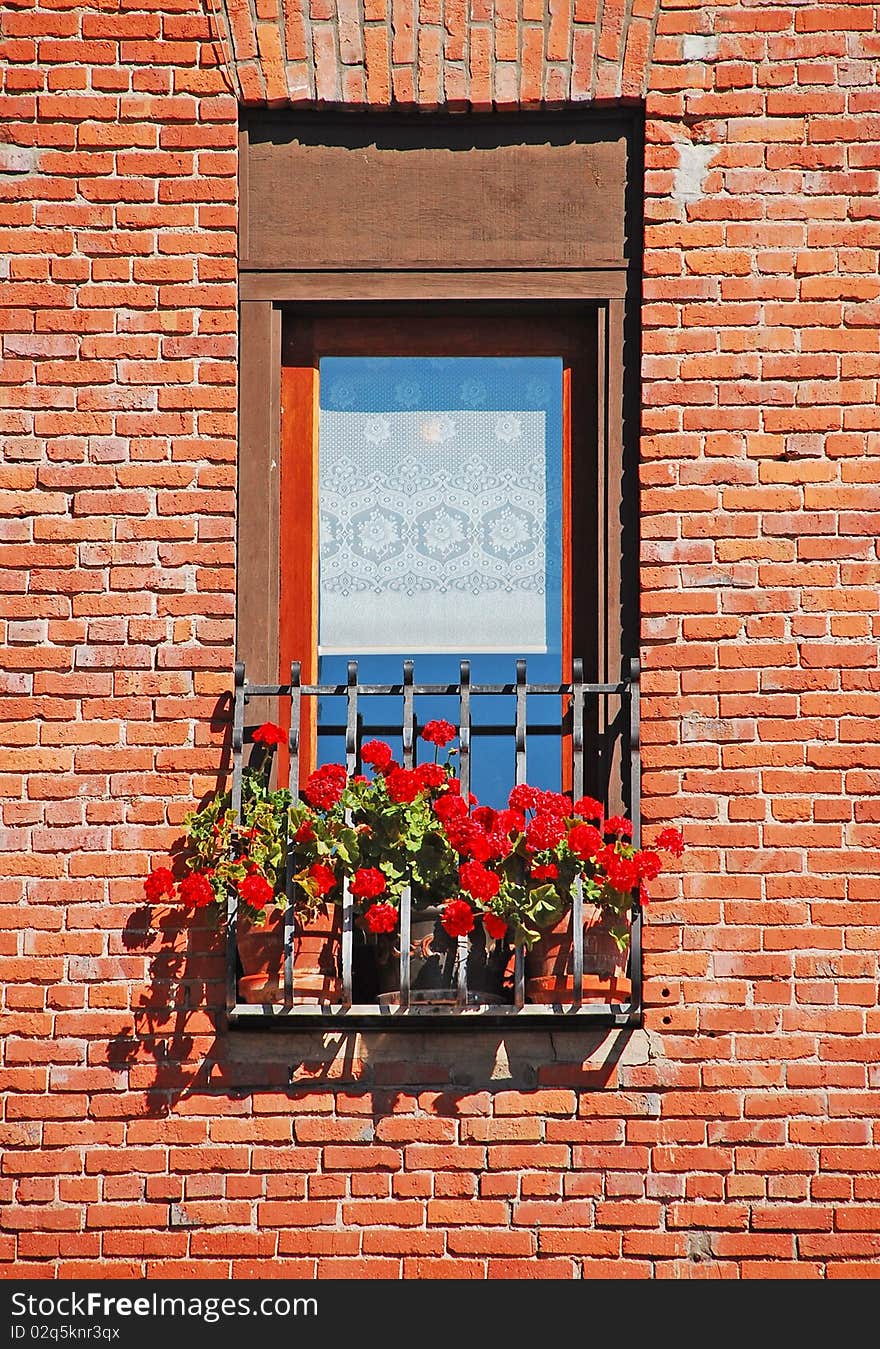 Window with flower planters in old brick wall. Window with flower planters in old brick wall