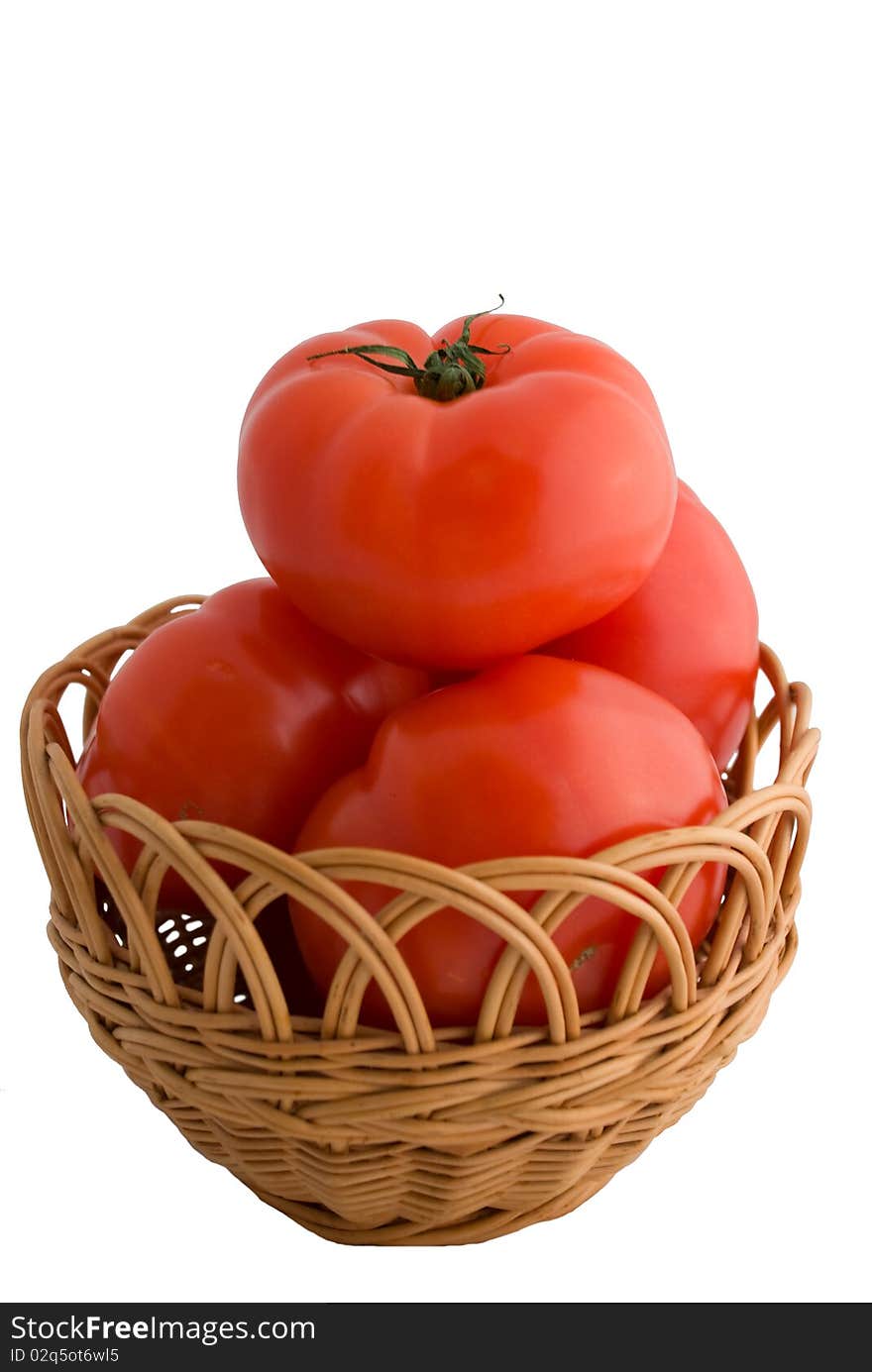 Red tomatoes with a basket isolated on white