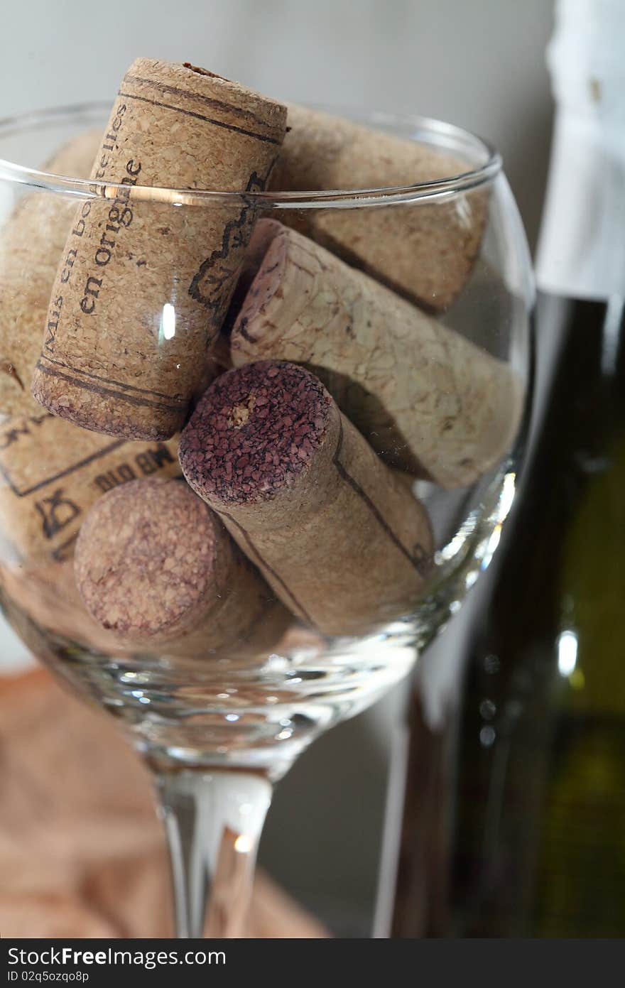 Image of a wine glass full of corks