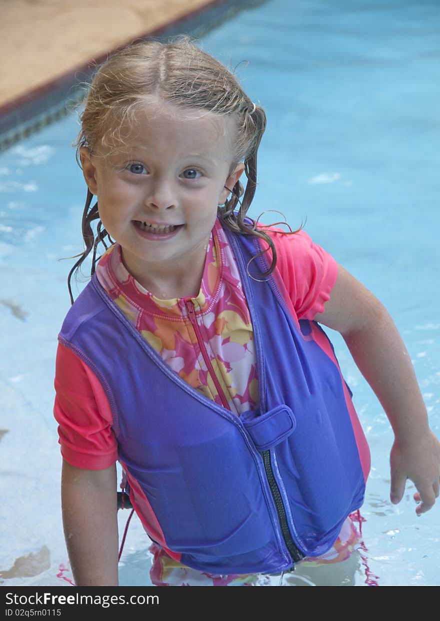 Photo image of a happy little girl in a swimming pool. Photo image of a happy little girl in a swimming pool