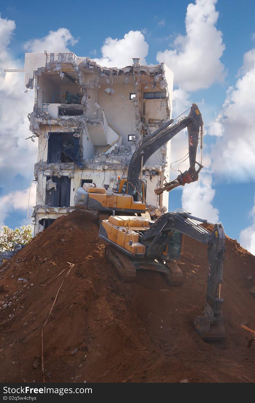 Tractors destroying a building