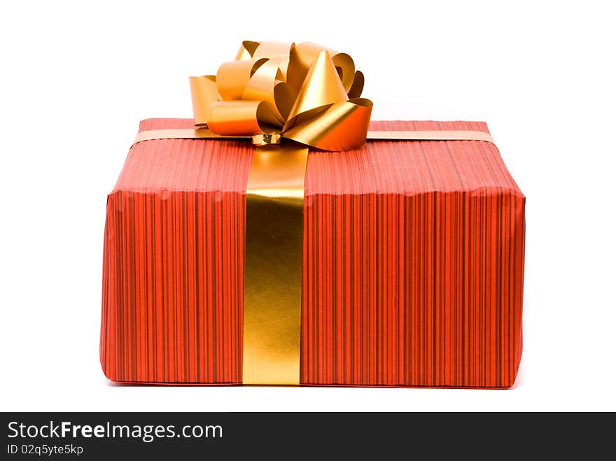 Red gift box with golden bow on a white background