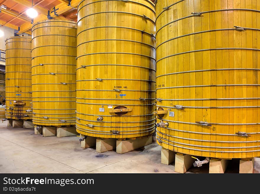 Large wooden casks in a California winery cellar. Large wooden casks in a California winery cellar.