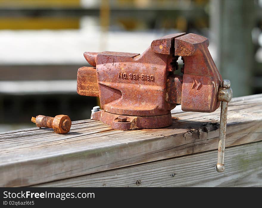 Old rusty vise  on wooden dock