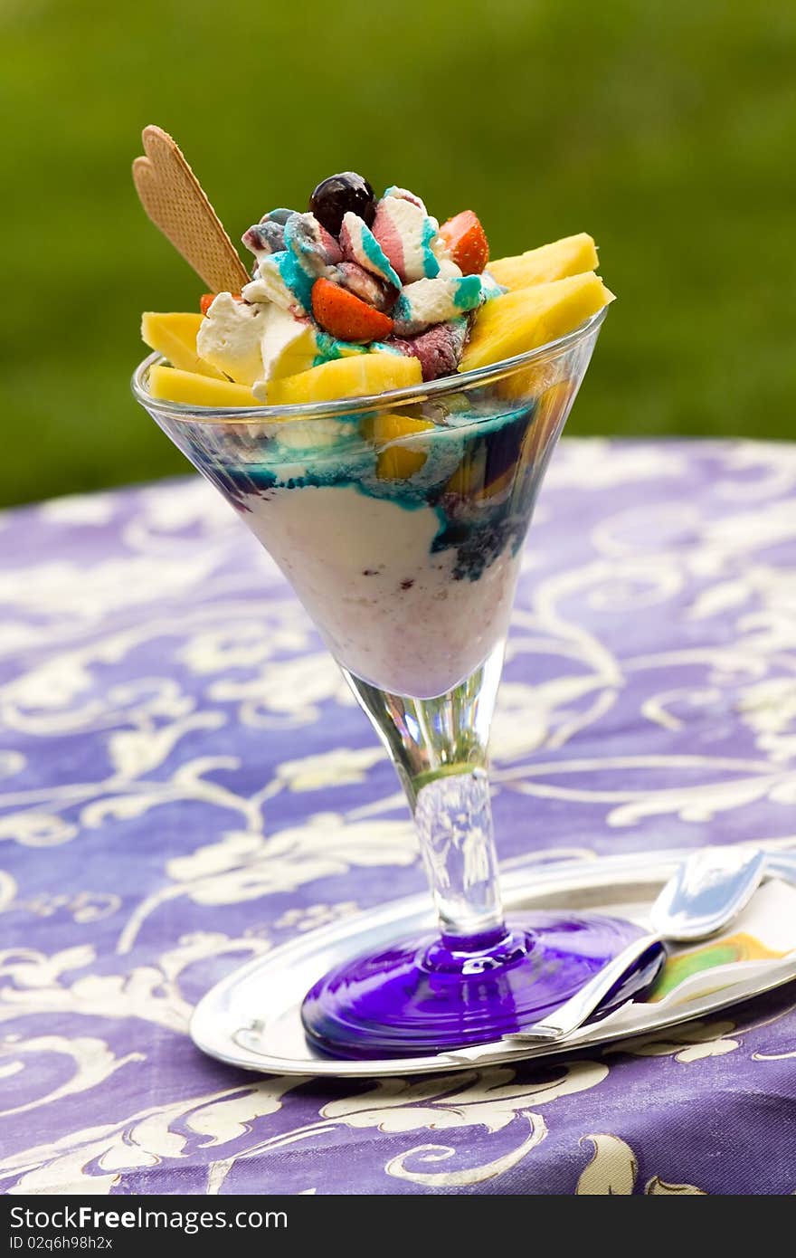 Ice Cream In Glass Bowl On Green Background