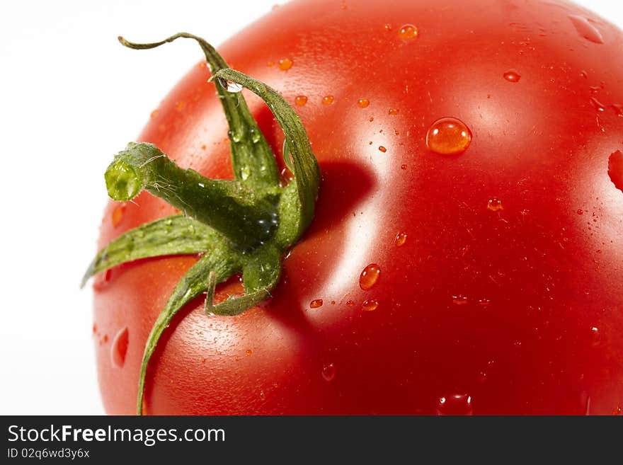 Close-up single tomato with waterdrops, isolated on white. Close-up single tomato with waterdrops, isolated on white.