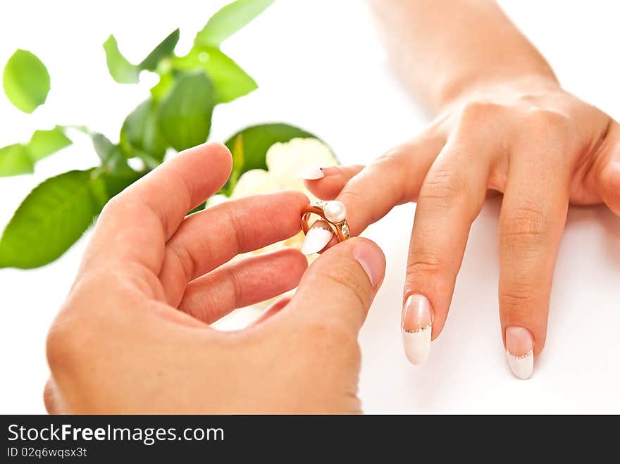 Man's and woman's hands with golden ring on white background. Man's and woman's hands with golden ring on white background