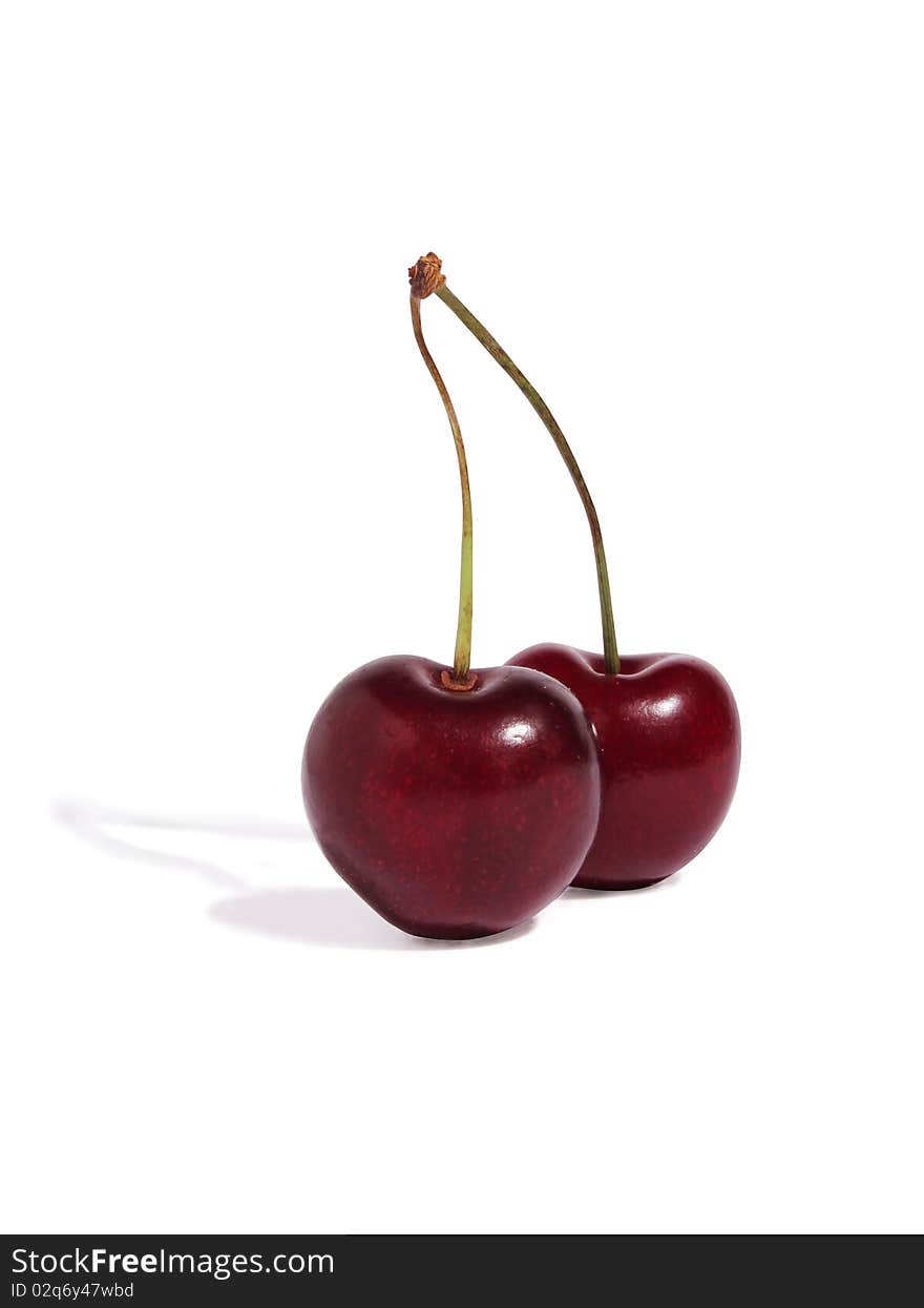 Two cherries on a white background