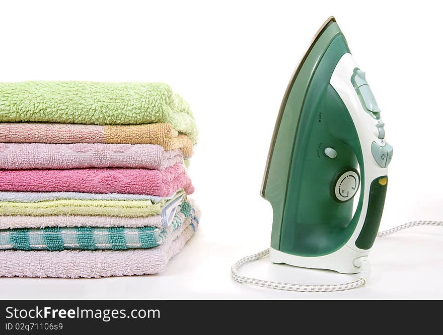 Iron and towels on a white background