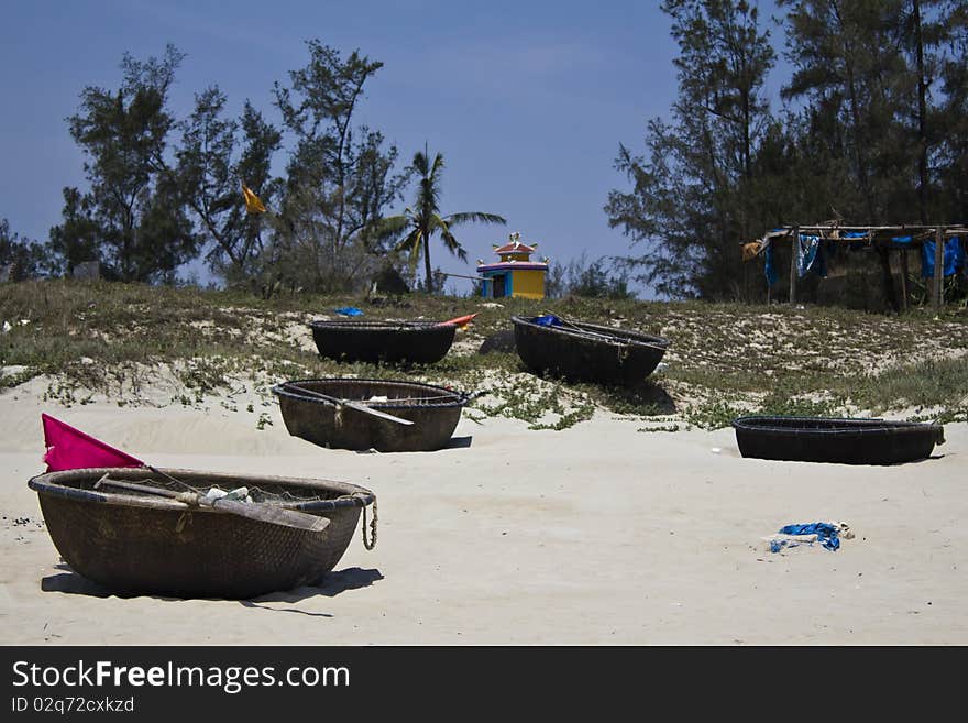 Traditional Vietnamese woven basket boats on a sandy beach. Traditional Vietnamese woven basket boats on a sandy beach.