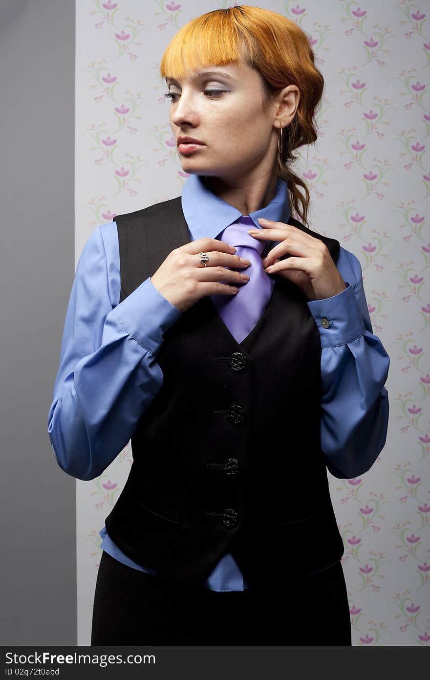 Young girl straightens his tie