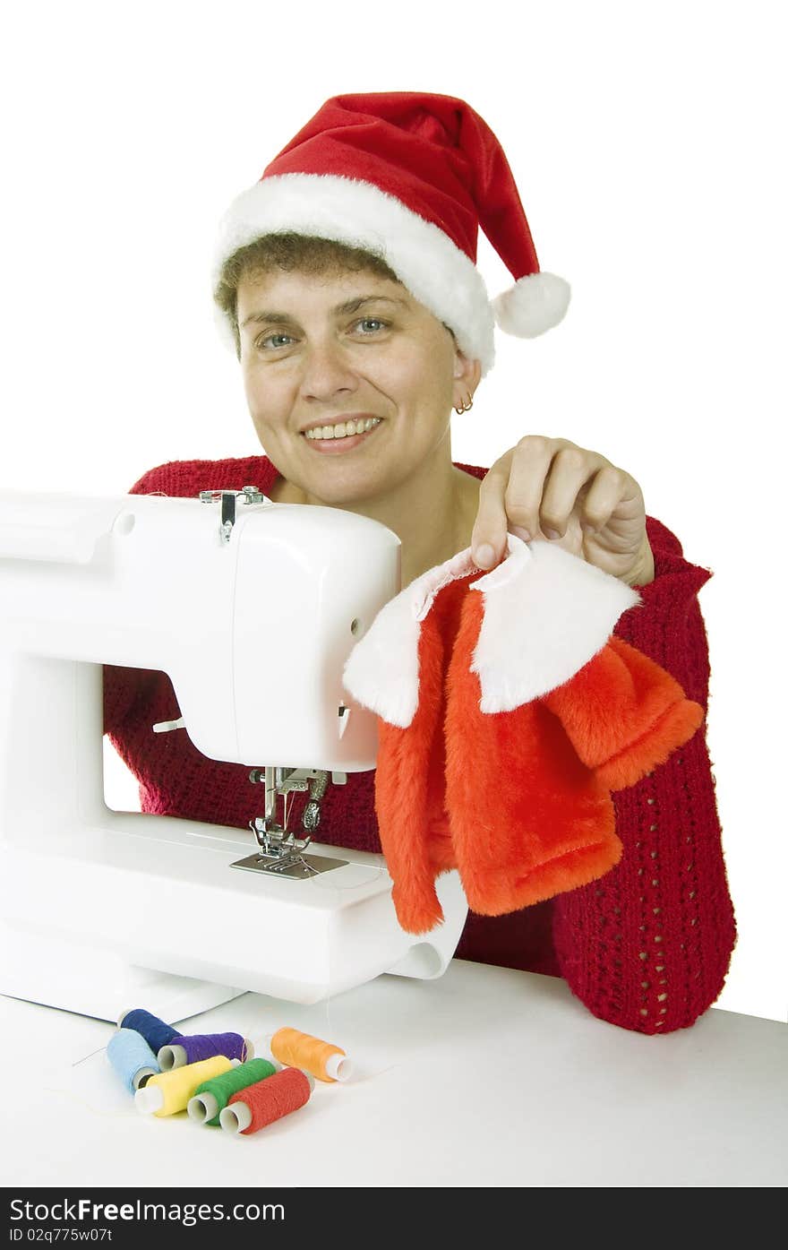 Woman sewing a fur coat for Santa Claus