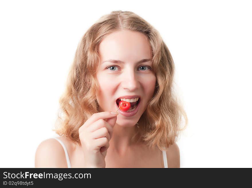 Beautiful young woman with cherries in the mouth isolated on a white background