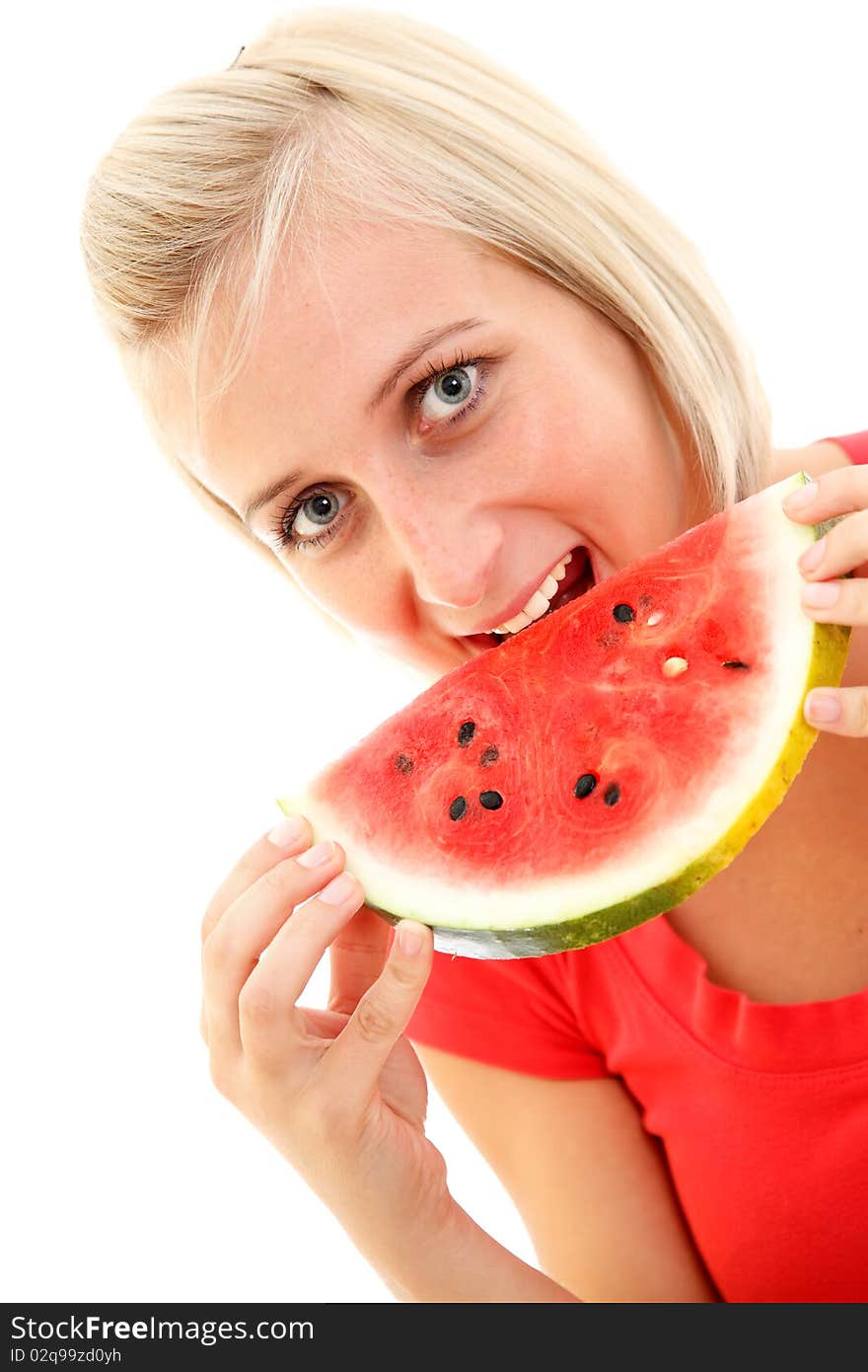 An attractive young girl eating a slice of watermelon. An attractive young girl eating a slice of watermelon