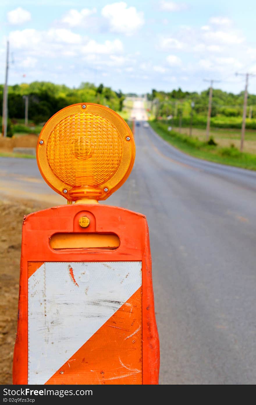 Traffic cone flasher on empty road