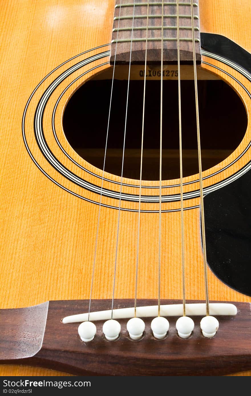 A closeup of an abstract classical acoustic guitar with strings