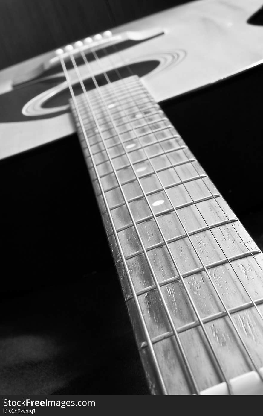 A closeup of an abstract classical acoustic guitar with strings