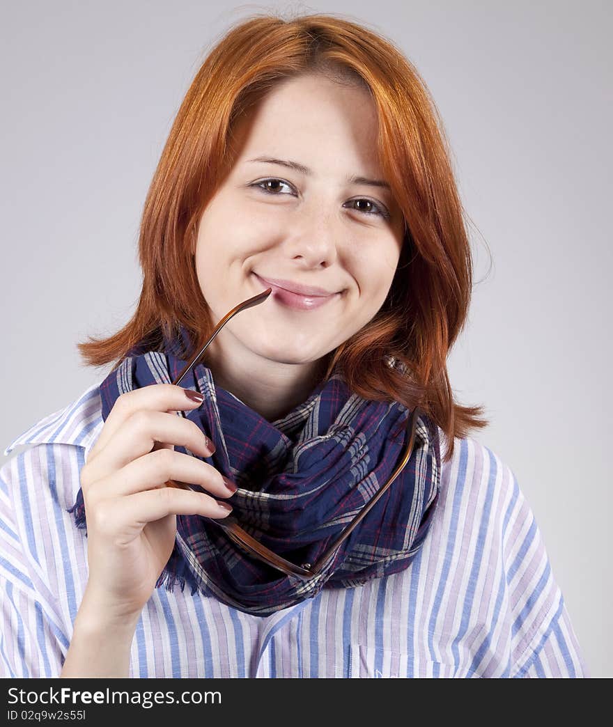 Young smiling fashion girl in glasses