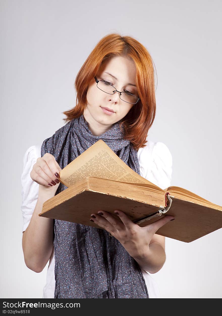 Young doubting fashion girl in glasses with old book. Young doubting fashion girl in glasses with old book