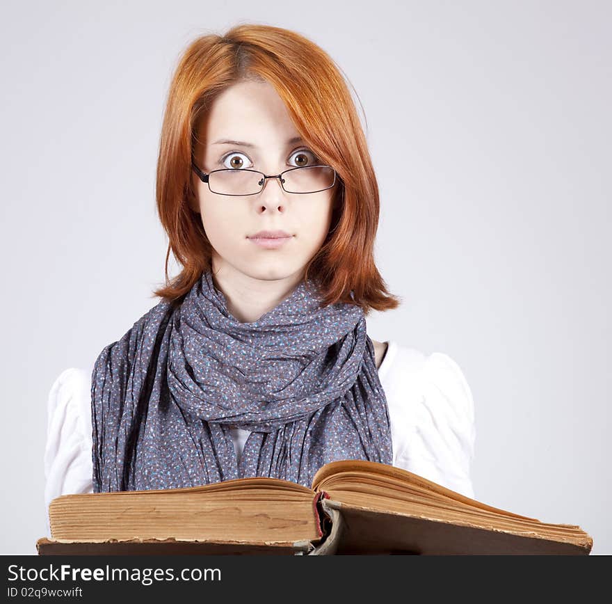 Doubting Girl In Glasses With Old Book