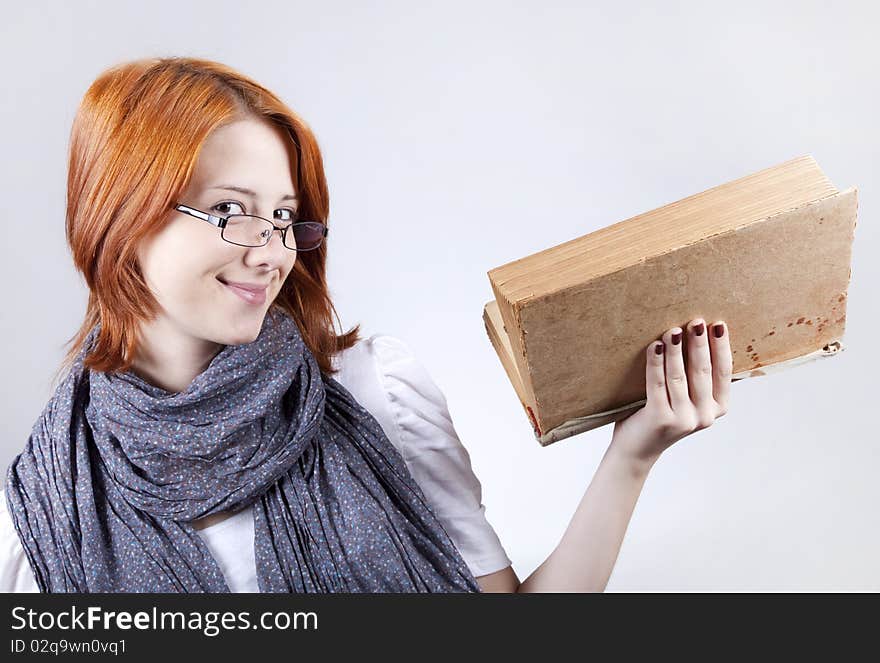 Young girl in glasses with age book.