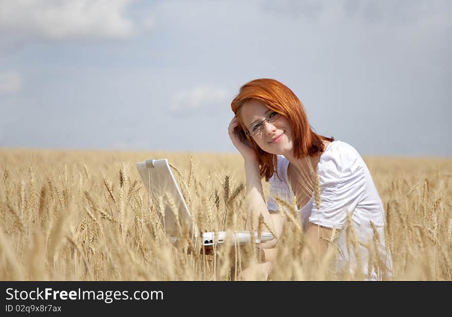 Businesswomen in white with notebook at wheat fiel