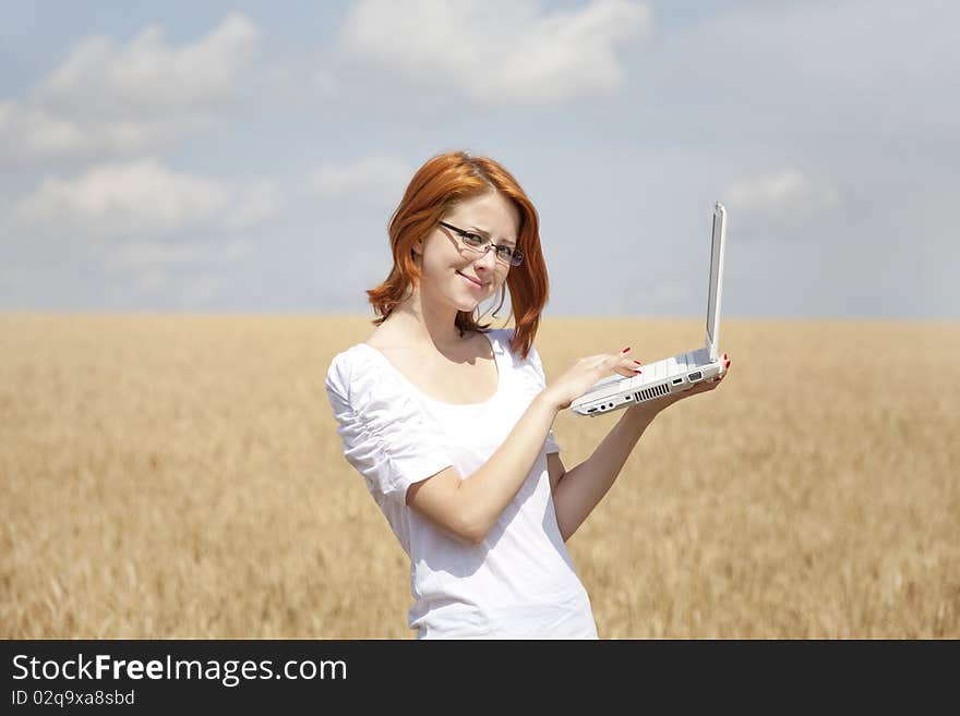 Businesswomen in white with notebook at wheat fiel