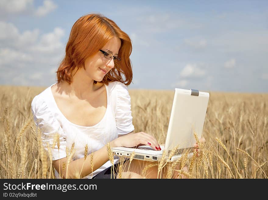 Businesswomen in white with notebook at wheat fiel