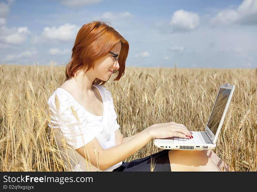 Businesswomen in white with notebook at wheat fiel