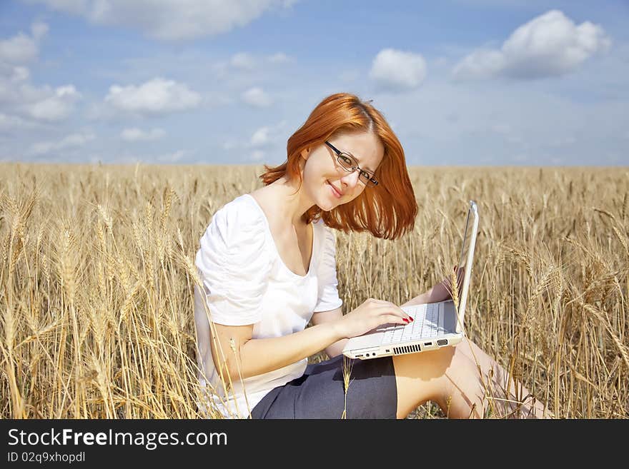 Businesswomen in white with notebook at wheat fiel