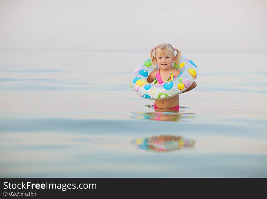 Small girl in water with inflatable buoy. Small girl in water with inflatable buoy