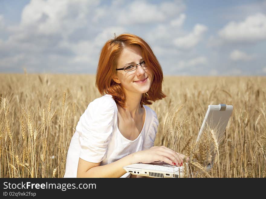 Businesswomen in white with notebook at wheat fiel