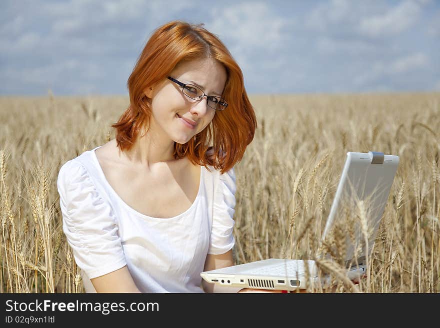 Young Businesswomen in white working with notebook at wheat field. Young Businesswomen in white working with notebook at wheat field.