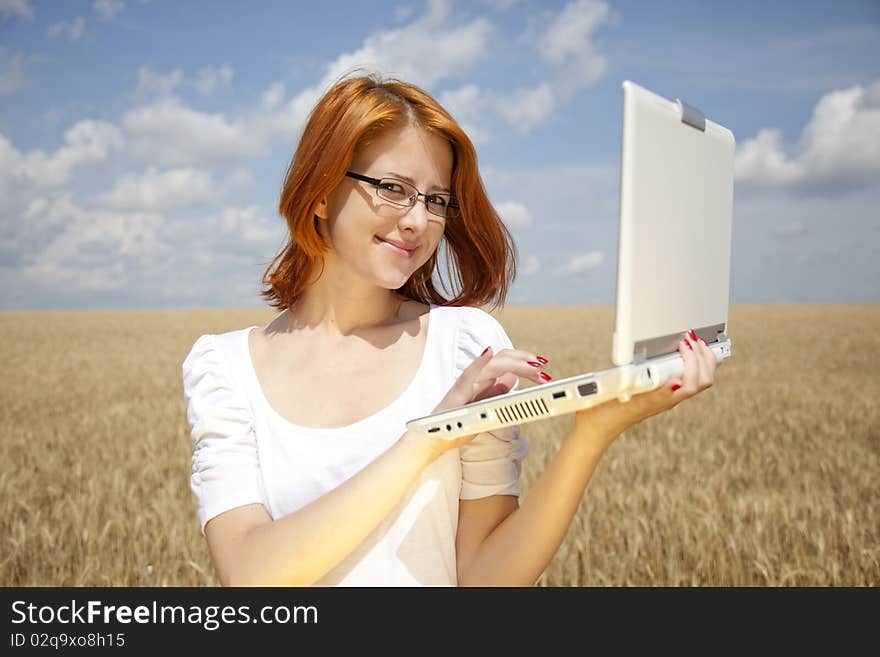 Young Businesswomen in white working with notebook at wheat field. Young Businesswomen in white working with notebook at wheat field.