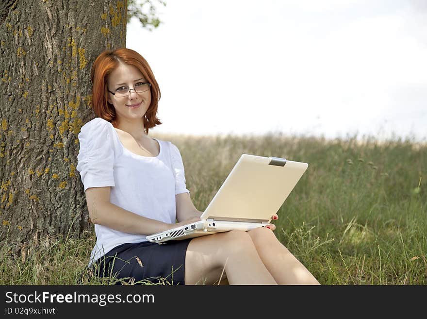 Businesswomen in white with glasses and laptop