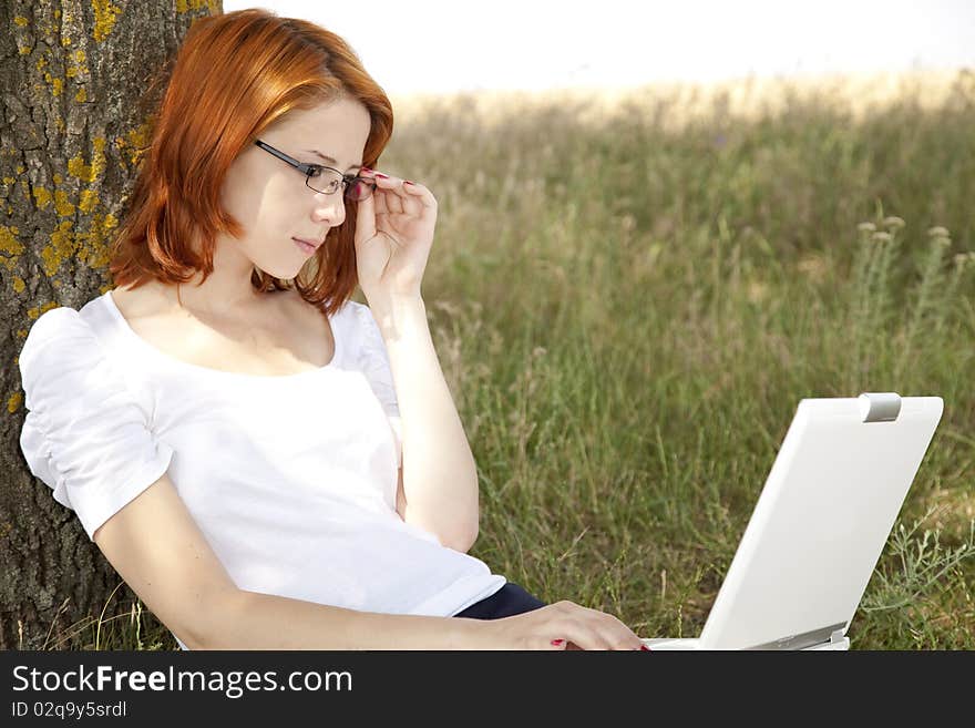 Businesswomen in white with glasses and laptop