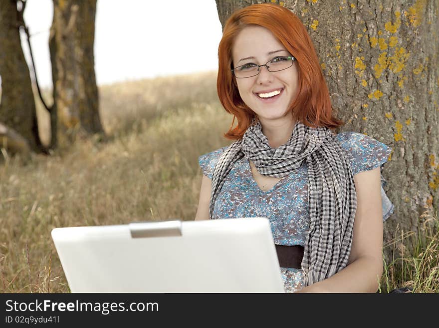 Young Smiling Girl In Glasses And Notebook