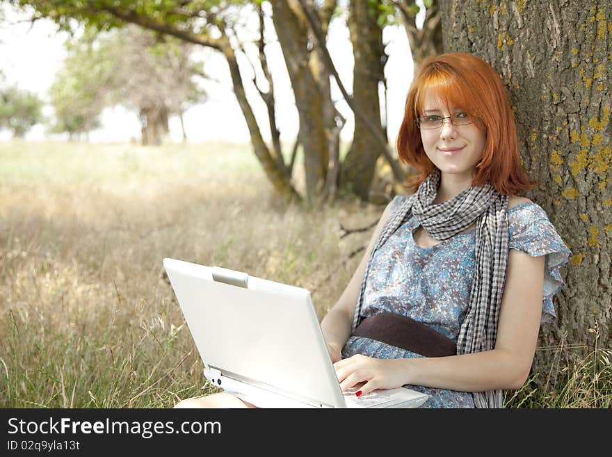 Young smiling girl in glasses and notebook