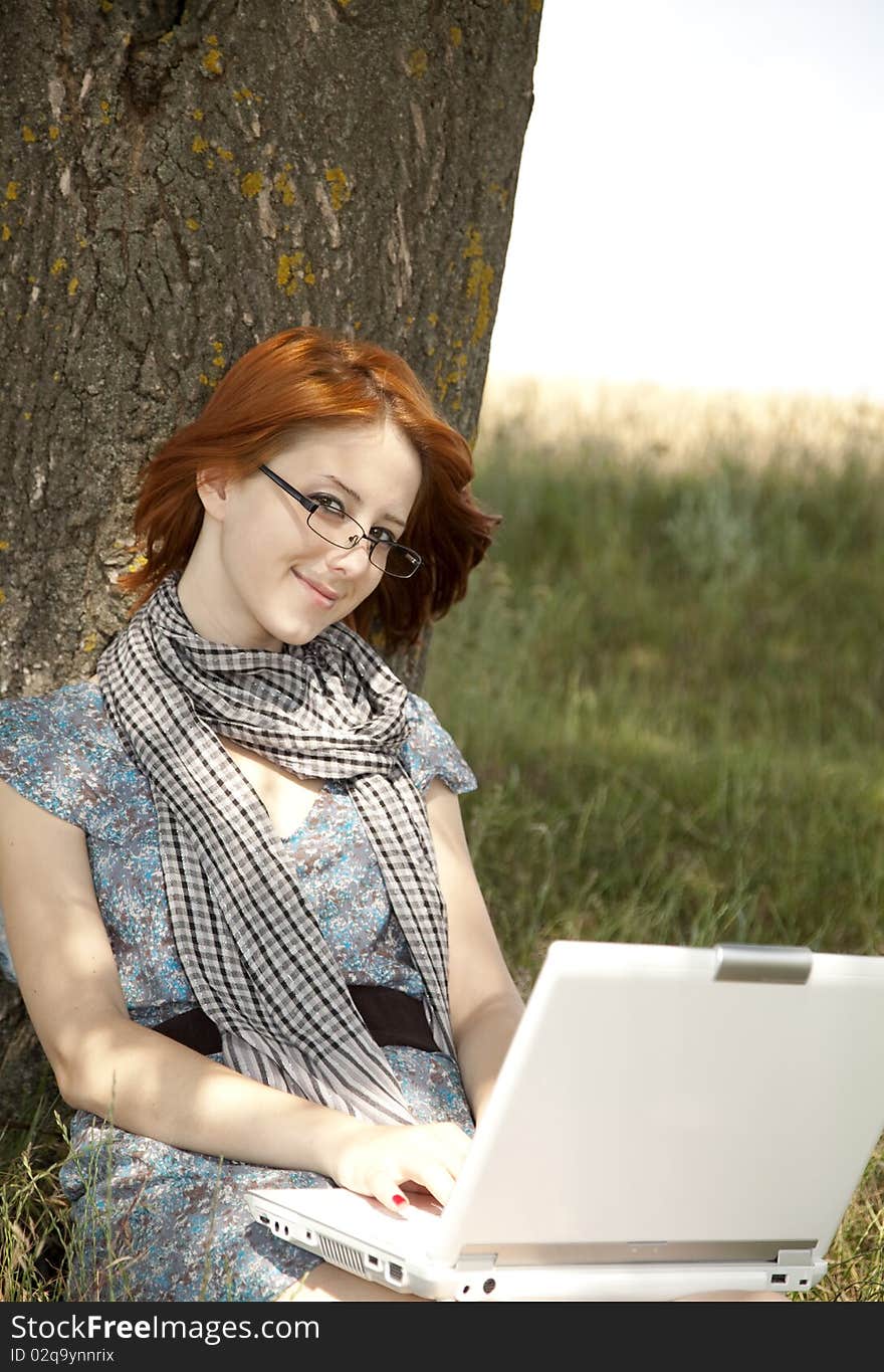 Young Smiling Girl In Glasses And Notebook