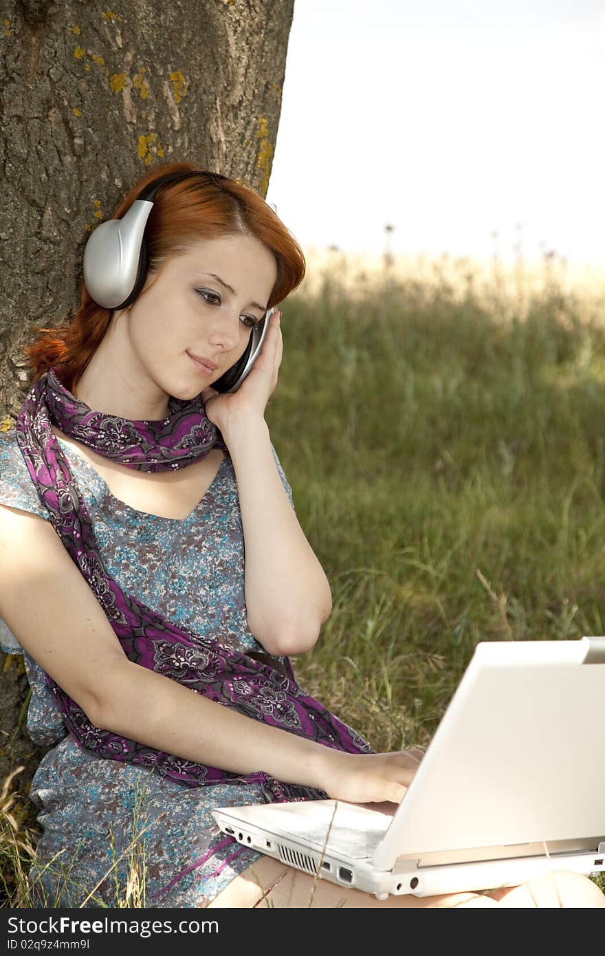 Young Smiling Girl With Notebook And Headphones