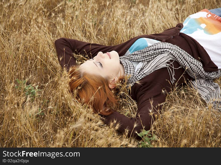 Young Beautiful Girl Lying At Yellow Autumn Field.