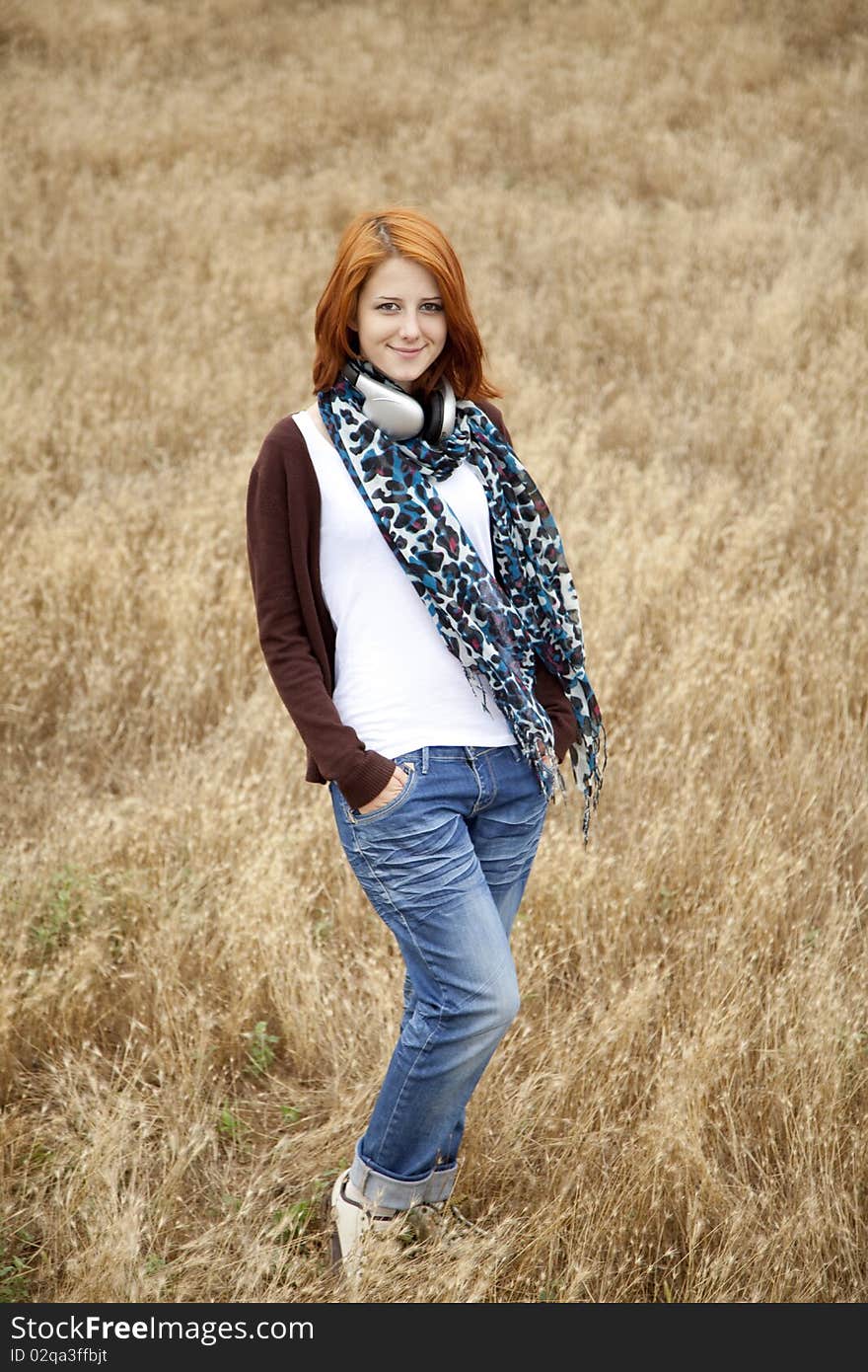 Young Girl With Headphones At Field.